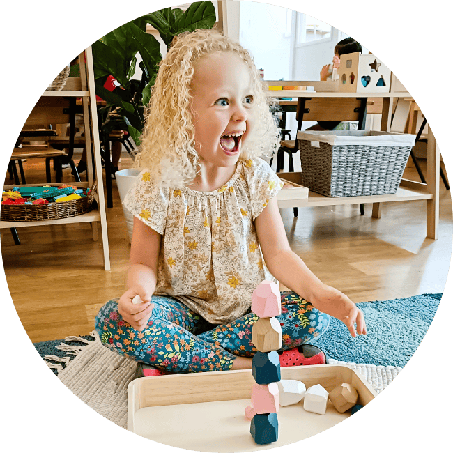 Kindergarten child enjoying mindful stacking of blocks
