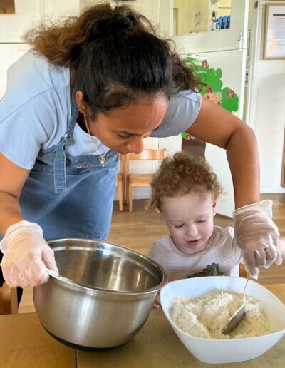 Learning practical life skills: taking turns in mixing the cookie dough ingredients.