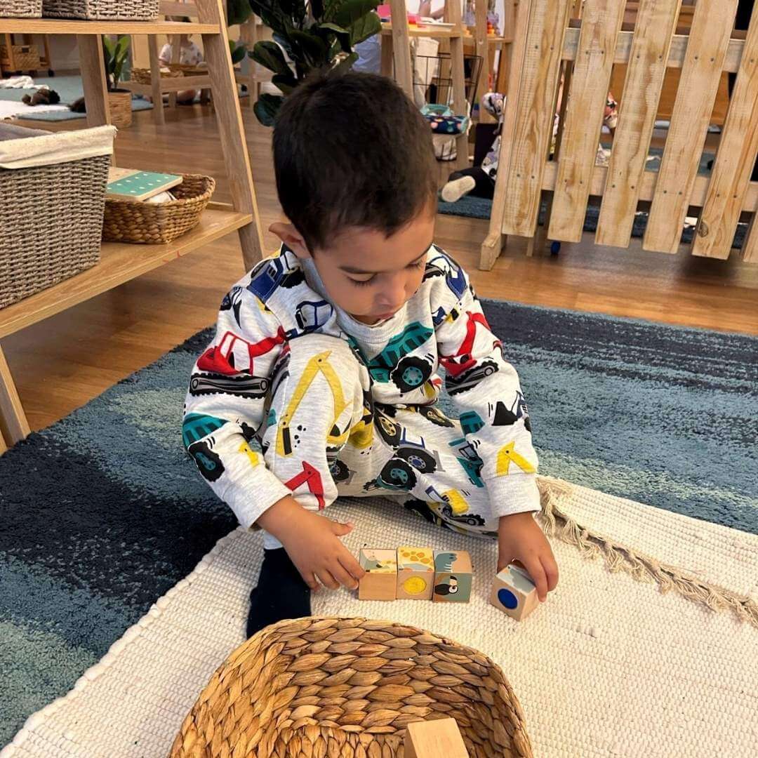 Playing with blocks on the mat